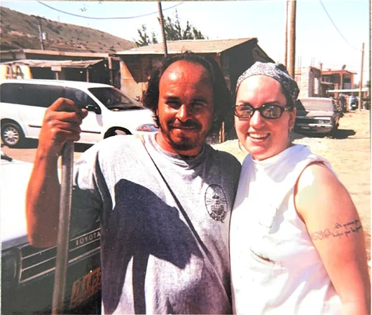 Julie Kline 2 White woman volunteer poses with brown Mexican man staff member in 1998