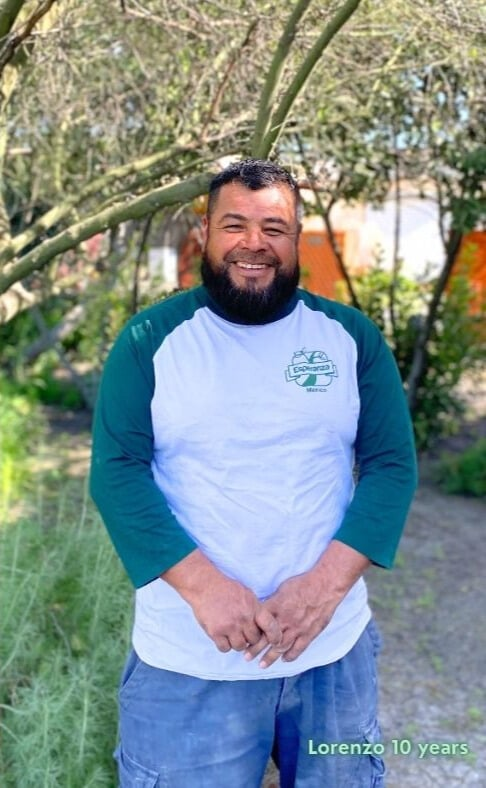 Lorenzo in an Esperanza shirt in the sun with text that says his name and "10 years"